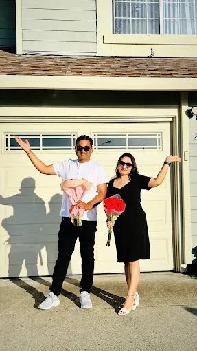 Buyers celebrating outside their new home